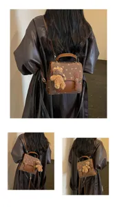 Brown mini backpack detail view with heart pattern and cute bear pendant, stylish and chic.