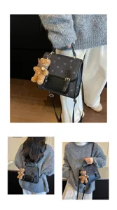 Close-up detail view of the fashionable color-block backpack with cute teddy bear plush pendant.