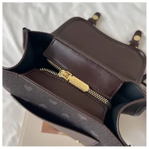 Detailed view of the stylish brown PU leather backpack featuring a secure gold zipper pull.