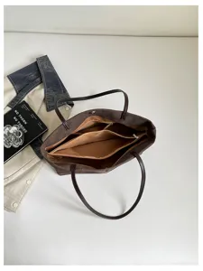 Vista interna dettagliata della borsa tote marrone da donna con motivo coccodrillo.