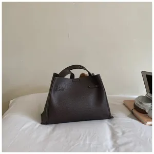 Dark brown pebbled leather handbag detail view, elegant minimalist daily tote bag for women.