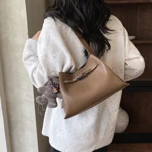Stylish women brown leather shoulder bag with chic metal turn-lock and cute bear charm for daily wear