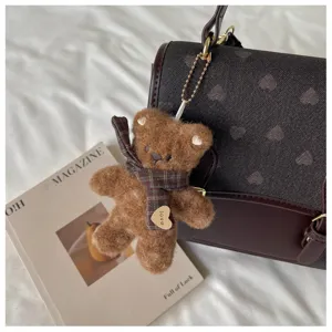 Plush brown bear keychain with plaid scarf, cute bag charm accessory for daily use.
