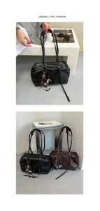 Detail view of stylish soft leather shoulder pillow bag, casual commuter tote with charm.