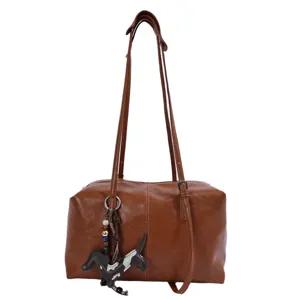 Brown PU leather shoulder bag with cute dog charm, casual daily commute pillow handbag.