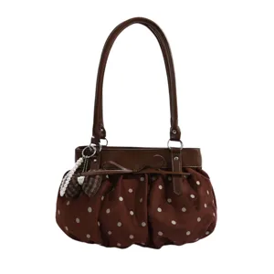 Stylish brown polka dot faux suede underarm bag with cute bow and pearl charm for women.