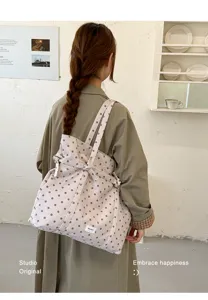 Stylish polka dot canvas tote bag, casual shoulder bag with strap detail, detailed view.