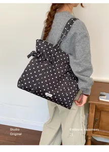 Polka dot tote bag detail, featuring casual commuting style and spacious design.