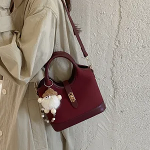 Wine red bucket bag for women stylish commuter tote bag with shoulder strap and cute charm.