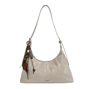 Stylish beige hobo shoulder bag for women, trendy dumpling crossbody bag with cute wooden charms.