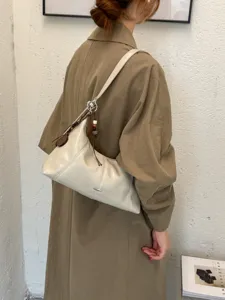 Minimalist beige underarm shoulder bag for women, stylish faux leather dumpling bag.