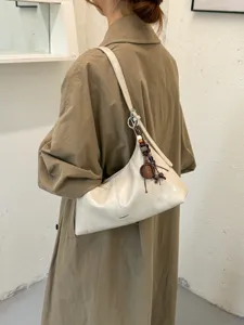 Stylish women's hobo shoulder bag with beaded charm, chic daily commuting crossbody purse.