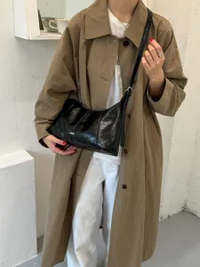 Minimalist black shiny shoulder bag, trendy dumpling bag for casual daily commute.