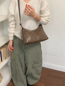 Stylish glossy brown hobo shoulder bag, casual chic dumpling crossbody bag for women daily commute.