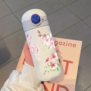 Ins style cherry blossom vacuum insulated water bottle with cute pink floral pattern daily use.