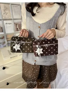 Detailed view of the vintage polka dot handbag featuring cute star pendant and design.