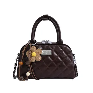 Dark brown quilted handbag detail, chic chain strap, elegant shoulder bag for women.