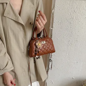 Brown quilted chain crossbody bag for women, elegant fashion handbag with chic flower charm.