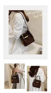 Detail view of stylish brown suede bucket bag with metal clasp and chic bead charms.