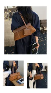 French vintage style brown suede shoulder bag with attached small pouch, casual detail shot.