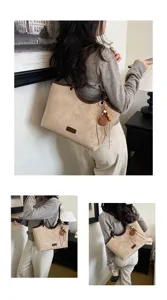 Retro suede tote bag for women, chic bucket shoulder bag with contrast trim and tassel charm.