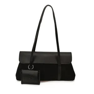 Detailed view of the black retro shoulder underarm bag showcasing suede texture, strap, and small pouch.