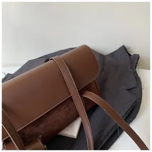 Close-up of vintage brown leather shoulder bag detail, elegant autumn minimalist design.