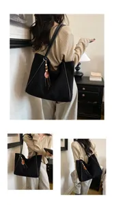 Black canvas tote bag with leather strap and wooden bead tassel, casual daily shoulder bag.