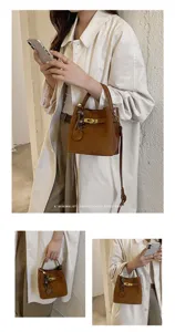 Detailed view of the stylish retro brown bucket bag with top handle and chic charm.