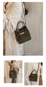 Stylish women's bucket bag with chic turn-lock closure and elegant shoulder strap design.