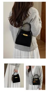 Women stylish black bucket bag with gold lock closure, casual shoulder crossbody bag.
