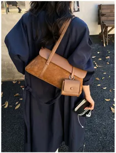 French retro minimalist shoulder bag, stylish autumn brown suede crossbody underarm bag detail.