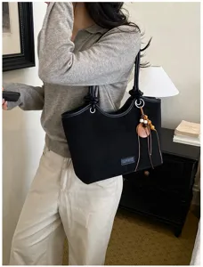 Classic black tote bag for women, stylish shoulder handbag with elegant knot details.