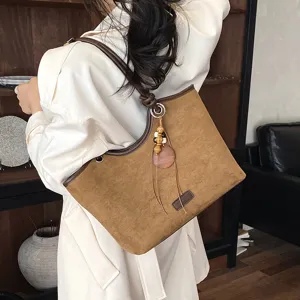 Chic retro brown suede tote bag for women, stylish shoulder handbag with tassel for autumn.