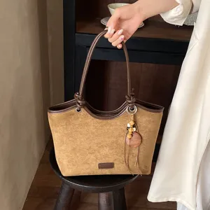 Vintage brown suede tote bag for women, stylish bucket handbag with wood bead charm.