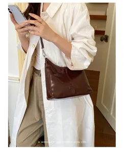 Minimalist brown underarm hobo bag for women, retro stylish shoulder bag for daily casual outfit.