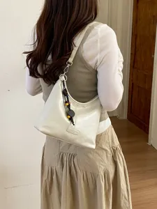 Casual minimalist white leather hobo shoulder bag with beaded charm detail for women.