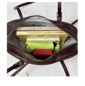 Detailed view of the dark brown shoulder bag interior capacity showing spacious storage.