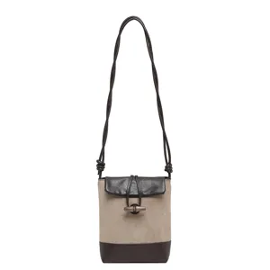 Small crossbody shoulder bag toggle closure casual brown canvas pu leather daily purse accessory.