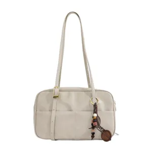 Detailed view of the retro leather underarm shoulder bag with chic wooden bead charm design.