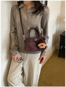 Chic suede crossbody shoulder bag for women, stylish brown handbag with cute bear pendant.