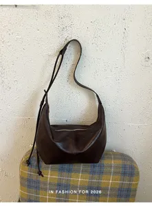 Retro brown leather shoulder bag, stylish hobo bag for women commuting daily wear.