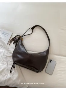 Retro brown PU leather hobo shoulder bag detail, soft slouchy design with side strap decor.