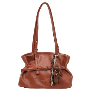 Detailed view of brown PU leather shoulder bag featuring cute teddy bear pendant and chic belt.