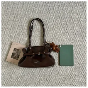 Detail view of the stylish dark brown shoulder tote bag with belt and bear charm.