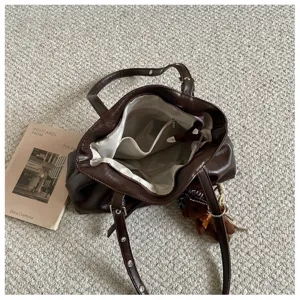 brown PU leather tote bag interior detail view with fabric lining and storage pockets