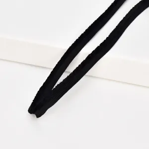 Close-up of black fuzzy plush binding tape trim, soft fabric accessory for DIY crafts.