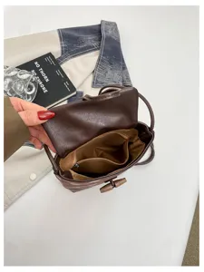 Brown leopard print bucket bag with toggle closure, interior zip pocket and shoulder strap.