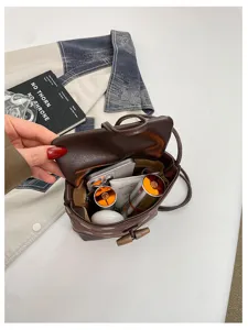 Brown leather bucket bag interior detail showing spacious capacity for daily essentials.