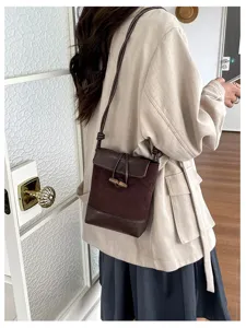 Stylish brown suede crossbody bag for women, mini messenger shoulder bag, casual purse.